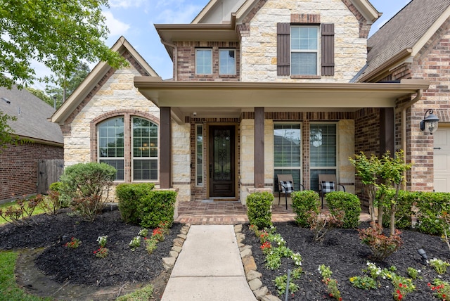 2678 Granite River Ln, Conroe, TX 77385 - entrance to property featuring a porch and stone siding