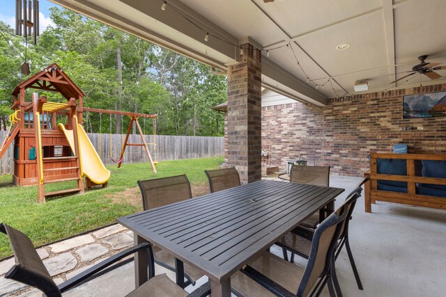 2678 Granite River Ln, Conroe, TX 77385 - view of patio / terrace with a playground, ceiling fan, outdoor dining area, and view of scattered trees