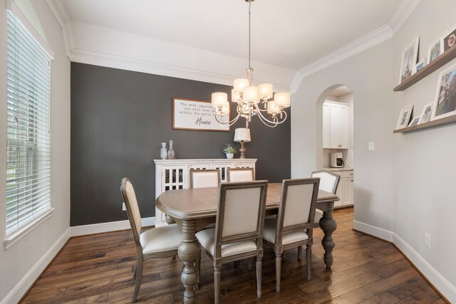 2678 Granite River Ln, Conroe, TX 77385 - dining space with crown molding, dark wood finished floors, arched walkways, a chandelier, and baseboards