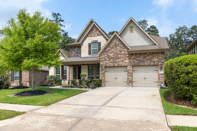 2678 Granite River Ln, Conroe, TX 77385 - craftsman-style house with concrete driveway, roof with shingles, a front yard, a porch, and stucco siding