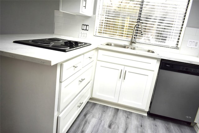 10011 Sageorchard Ln, Houston, TX 77089 - kitchen with dishwasher, a sink, white cabinetry, and decorative backsplash