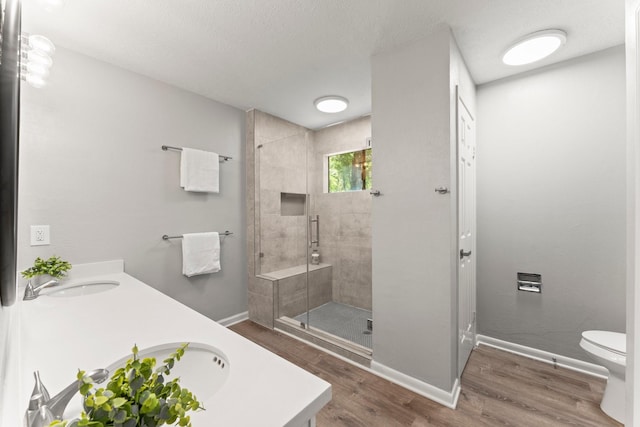 235 E Rainbow Ridge Cir, The Woodlands, TX 77381 - bathroom with double vanity, a shower stall, and wood finished floors