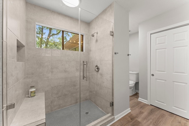 235 E Rainbow Ridge Cir, The Woodlands, TX 77381 - full bathroom featuring a stall shower and wood finished floors