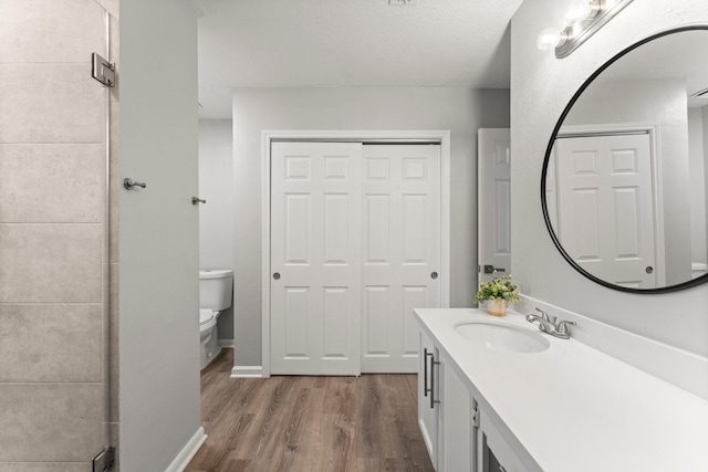 235 E Rainbow Ridge Cir, The Woodlands, TX 77381 - bathroom with wood finished floors, vanity, and a shower stall