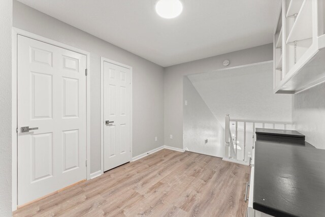 235 E Rainbow Ridge Cir, The Woodlands, TX 77381 - unfurnished living room featuring light wood-style floors