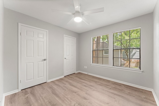 235 E Rainbow Ridge Cir, The Woodlands, TX 77381 - unfurnished bedroom with light wood-style floors and a ceiling fan