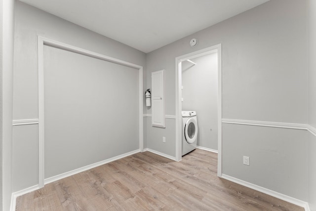 235 E Rainbow Ridge Cir, The Woodlands, TX 77381 - washroom featuring washer / clothes dryer and light wood finished floors