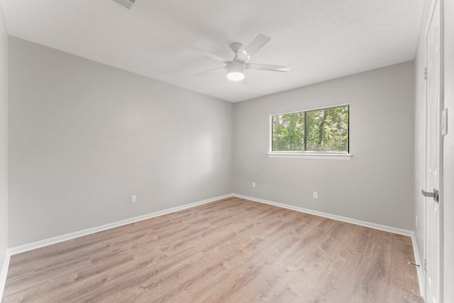 235 E Rainbow Ridge Cir, The Woodlands, TX 77381 - spare room with ceiling fan and light wood-style flooring