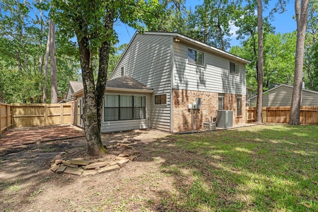 235 E Rainbow Ridge Cir, The Woodlands, TX 77381 - rear view of property with brick siding and a fenced backyard