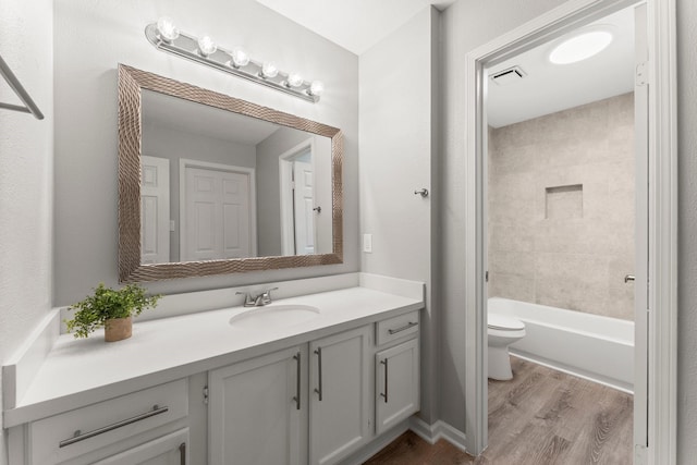 235 E Rainbow Ridge Cir, The Woodlands, TX 77381 - bathroom featuring vanity, wood finished floors, and shower / bathtub combination