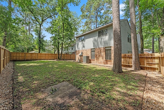 235 E Rainbow Ridge Cir, The Woodlands, TX 77381 - back of house with brick siding and a fenced backyard