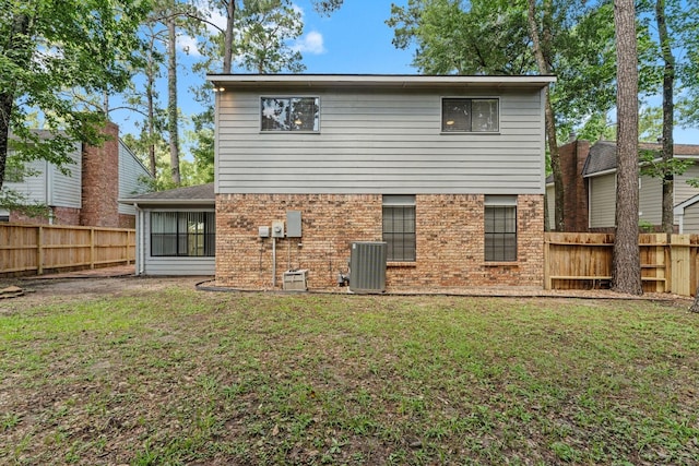 235 E Rainbow Ridge Cir, The Woodlands, TX 77381 - back of house featuring a fenced backyard and brick siding
