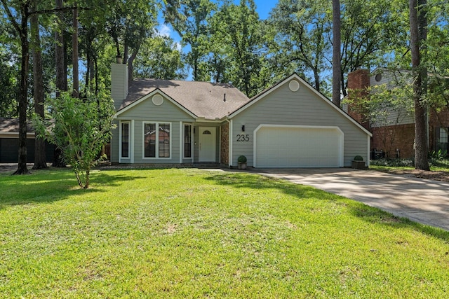 235 E Rainbow Ridge Cir, The Woodlands, TX 77381 - view of front of property with a garage, a chimney, concrete driveway, and a front lawn