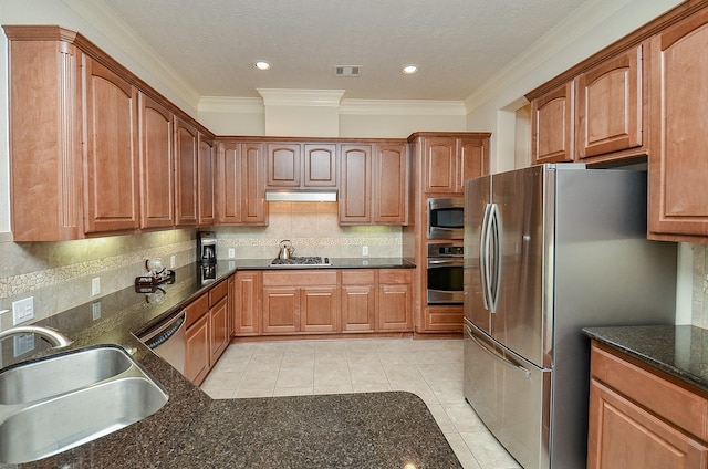 2918 Royal Oaks Grn, Houston, TX 77082 - kitchen with stainless steel appliances, a sink, tasteful backsplash, light tile patterned flooring, and under cabinet range hood