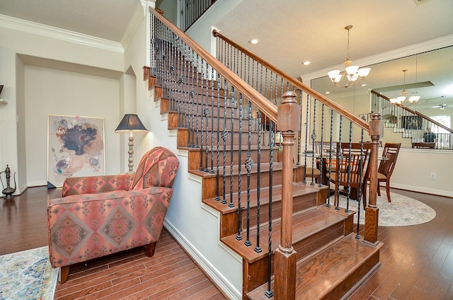 2918 Royal Oaks Grn, Houston, TX 77082 - stairway featuring crown molding, a chandelier, baseboards, wood finished floors, and recessed lighting