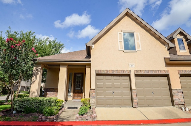 2918 Royal Oaks Grn, Houston, TX 77082 - view of property featuring stone siding, stucco siding, and an attached garage