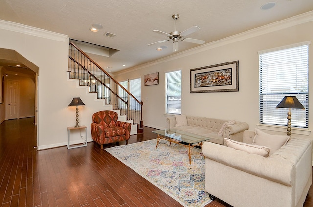 2918 Royal Oaks Grn, Houston, TX 77082 - living room featuring crown molding, a ceiling fan, arched walkways, baseboards, and dark wood-style flooring