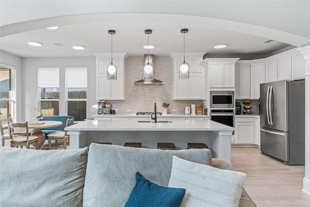 271 Bronze View Dr, Montgomery, TX 77316 - kitchen with stainless steel appliances, wall chimney range hood, a sink, and light countertops