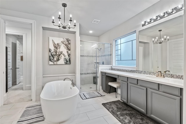 271 Bronze View Dr, Montgomery, TX 77316 - bathroom featuring a chandelier, vanity, a shower stall, a soaking tub, and tile patterned floors