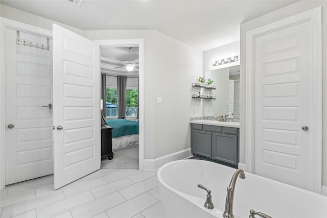 271 Bronze View Dr, Montgomery, TX 77316 - bathroom featuring a freestanding bath, vanity, a ceiling fan, baseboards, and ensuite bath