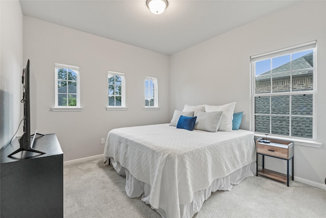 271 Bronze View Dr, Montgomery, TX 77316 - bedroom with light colored carpet, baseboards, and multiple windows