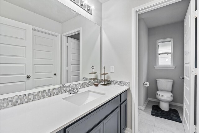 271 Bronze View Dr, Montgomery, TX 77316 - bathroom with vanity, toilet, baseboards, and tile patterned floors
