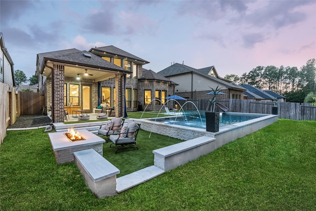 271 Bronze View Dr, Montgomery, TX 77316 - back of property featuring an outdoor living space with a fire pit, brick siding, and a shingled roof