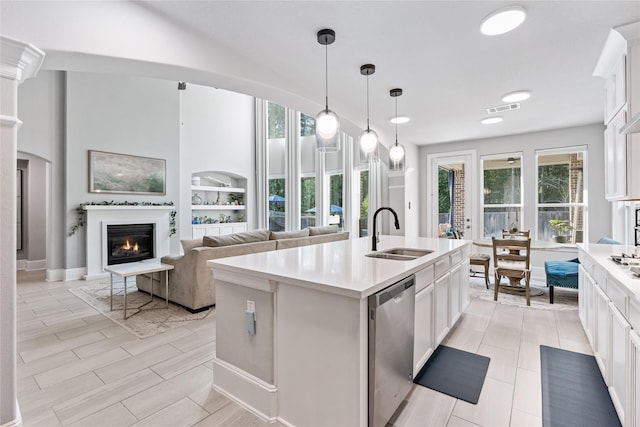 271 Bronze View Dr, Montgomery, TX 77316 - kitchen featuring a sink, dishwasher, a glass covered fireplace, and plenty of natural light