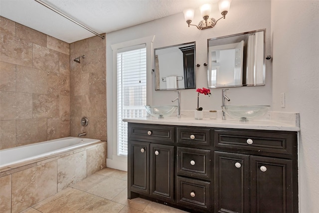 615 Allston St, Houston, TX 77007 - full bath with tile patterned flooring, double vanity, and tiled shower / bath combo