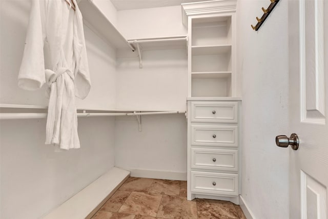 615 Allston St, Houston, TX 77007 - walk in closet featuring light stone finish flooring