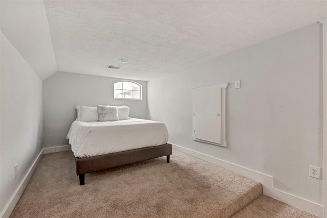 615 Allston St, Houston, TX 77007 - carpeted bedroom with vaulted ceiling, a textured ceiling, and baseboards