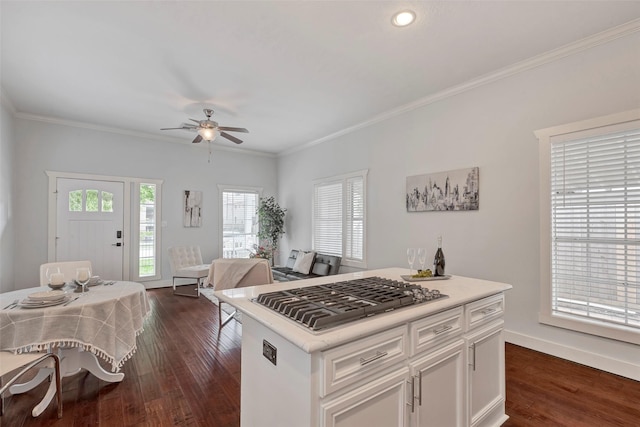 615 Allston St, Houston, TX 77007 - kitchen featuring stainless steel gas cooktop, a ceiling fan, dark wood finished floors, white cabinets, and light countertops
