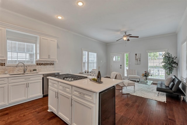 615 Allston St, Houston, TX 77007 - kitchen with a sink, beverage cooler, stainless steel appliances, dark wood-style floors, and ceiling fan