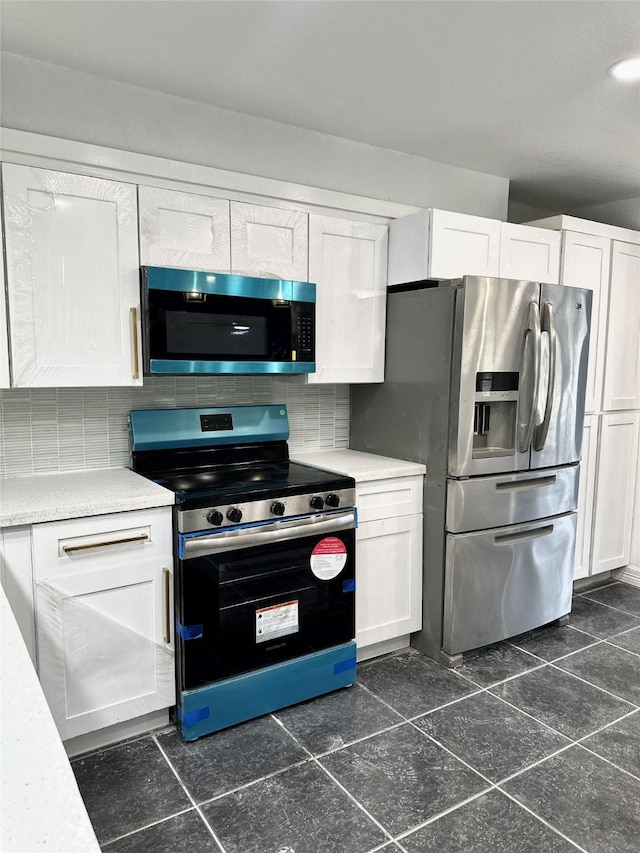 312 Bridal Wreath Ave, Orange, TX 77630 - kitchen with appliances with stainless steel finishes, white cabinets, and light countertops