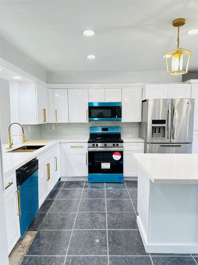 312 Bridal Wreath Ave, Orange, TX 77630 - kitchen featuring stainless steel appliances, a sink, light countertops, white cabinetry, and decorative backsplash