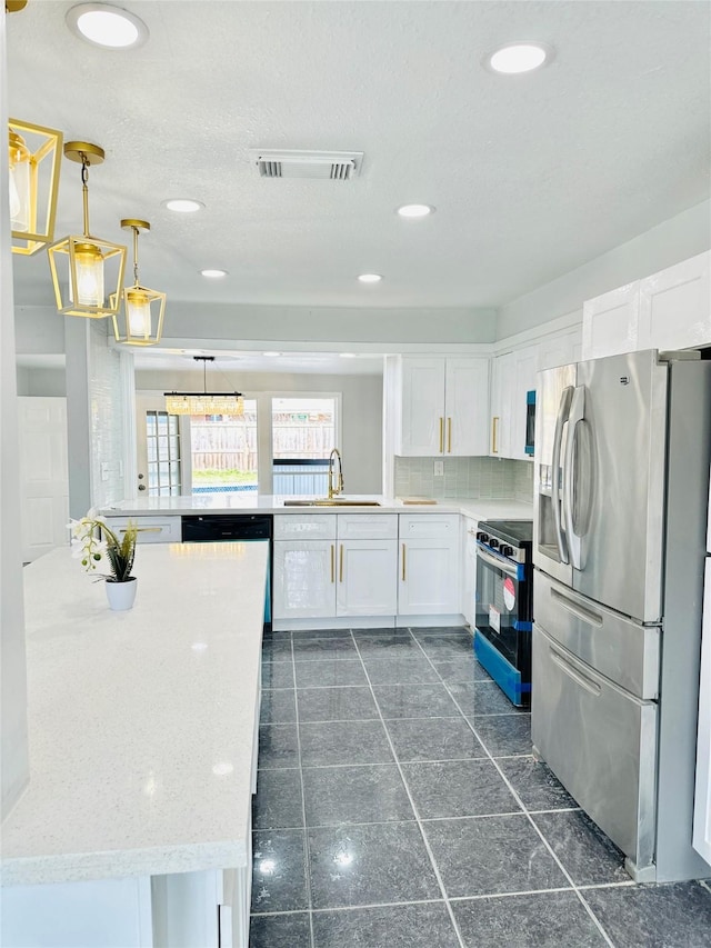 312 Bridal Wreath Ave, Orange, TX 77630 - kitchen with stainless steel appliances, a sink, white cabinetry, tasteful backsplash, and recessed lighting