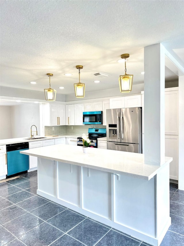 312 Bridal Wreath Ave, Orange, TX 77630 - kitchen featuring appliances with stainless steel finishes, a sink, light countertops, white cabinetry, and recessed lighting