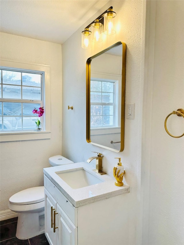 312 Bridal Wreath Ave, Orange, TX 77630 - bathroom with vanity, plenty of natural light, toilet, and tile patterned floors