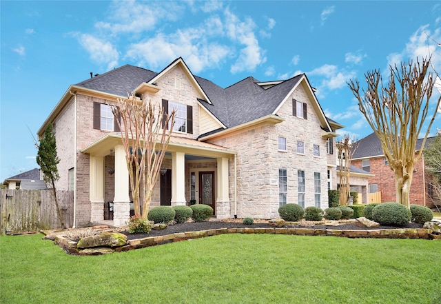 6002 Shady Birch Holw, Kingwood, TX 77345 - craftsman-style house with stone siding, a shingled roof, covered porch, and brick siding
