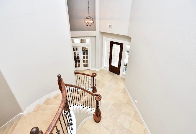 6002 Shady Birch Holw, Kingwood, TX 77345 - foyer with a chandelier, light tile patterned flooring, baseboards, and stairs