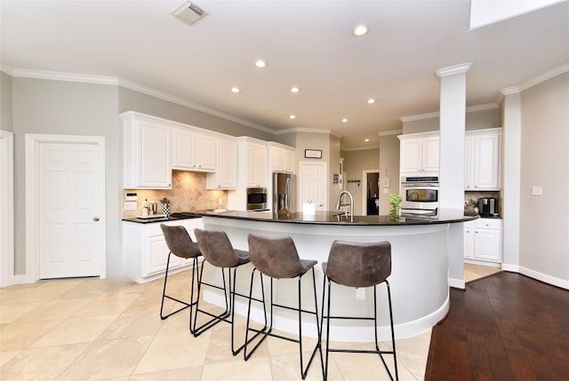6002 Shady Birch Holw, Kingwood, TX 77345 - kitchen with appliances with stainless steel finishes, dark countertops, recessed lighting, a large island, and tasteful backsplash