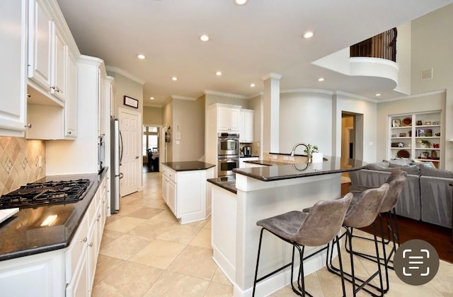 6002 Shady Birch Holw, Kingwood, TX 77345 - kitchen featuring a large island, appliances with stainless steel finishes, dark countertops, recessed lighting, and open floor plan