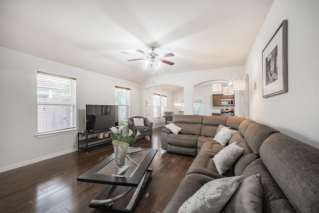 9609 Landon Lake Dr, Pearland, TX 77584 - living room featuring arched walkways, a ceiling fan, dark wood finished floors, and baseboards