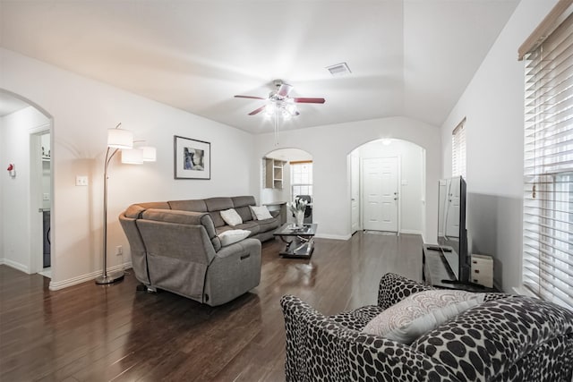 9609 Landon Lake Dr, Pearland, TX 77584 - living room with ceiling fan, arched walkways, dark wood-style flooring, and baseboards