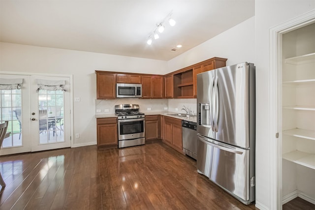 9609 Landon Lake Dr, Pearland, TX 77584 - kitchen with appliances with stainless steel finishes, open shelves, a sink, dark wood finished floors, and brown cabinetry
