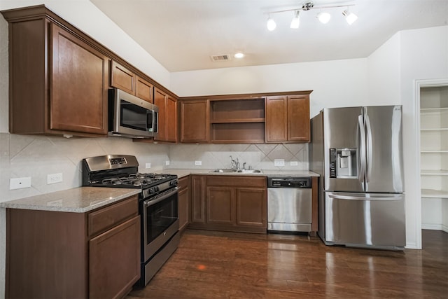 9609 Landon Lake Dr, Pearland, TX 77584 - kitchen with stainless steel appliances, open shelves, dark wood finished floors, light stone countertops, and a sink