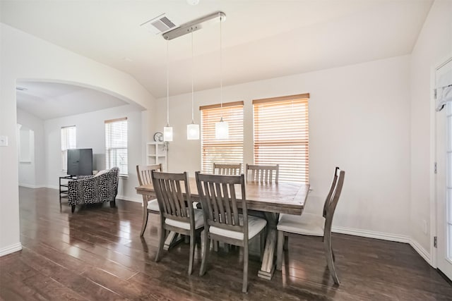 9609 Landon Lake Dr, Pearland, TX 77584 - dining area with dark wood finished floors, vaulted ceiling, baseboards, and arched walkways