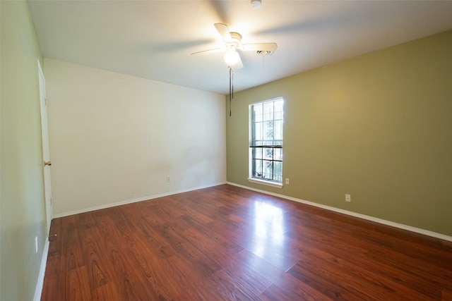 7613 Parker Rd, Houston, TX 77016 - spare room featuring ceiling fan, dark wood-style floors, and baseboards