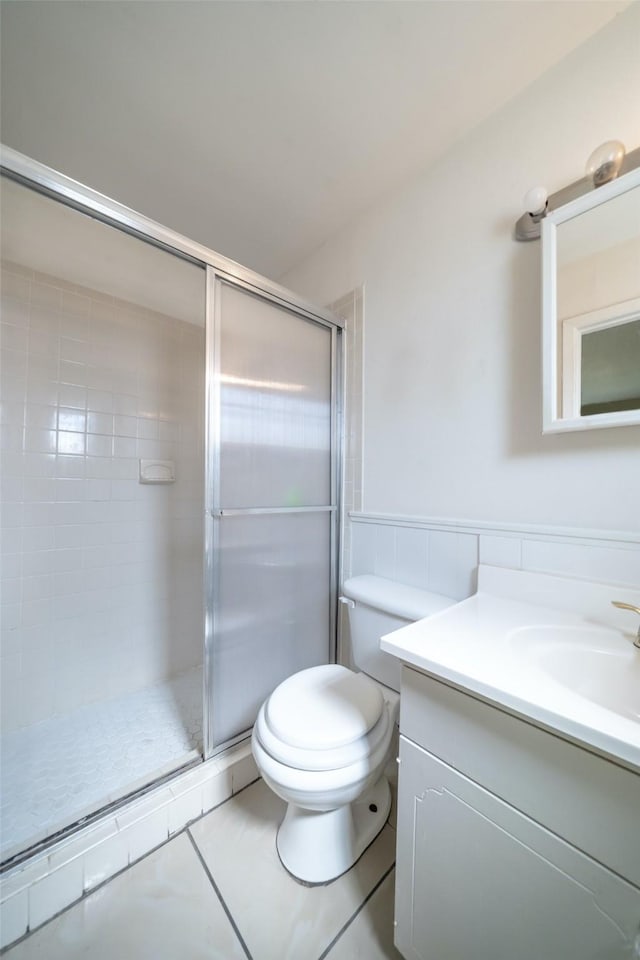 7613 Parker Rd, Houston, TX 77016 - bathroom with vanity, tile patterned floors, a stall shower, and toilet