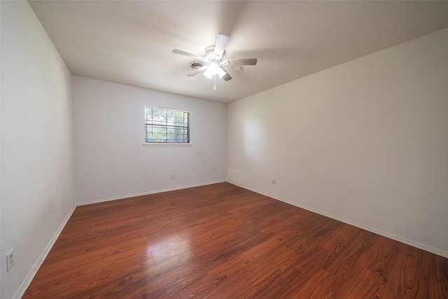 7613 Parker Rd, Houston, TX 77016 - spare room featuring dark wood-type flooring, ceiling fan, and baseboards